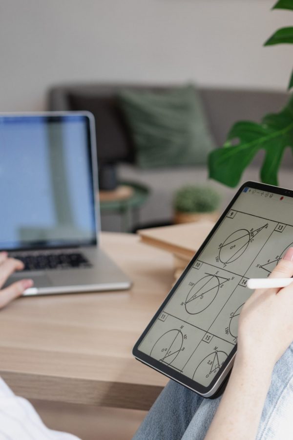 Young beautiful woman student with digital tablet and laptop studying working at home